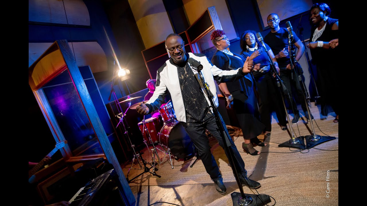 Philip Olaomi performing live with a worship team